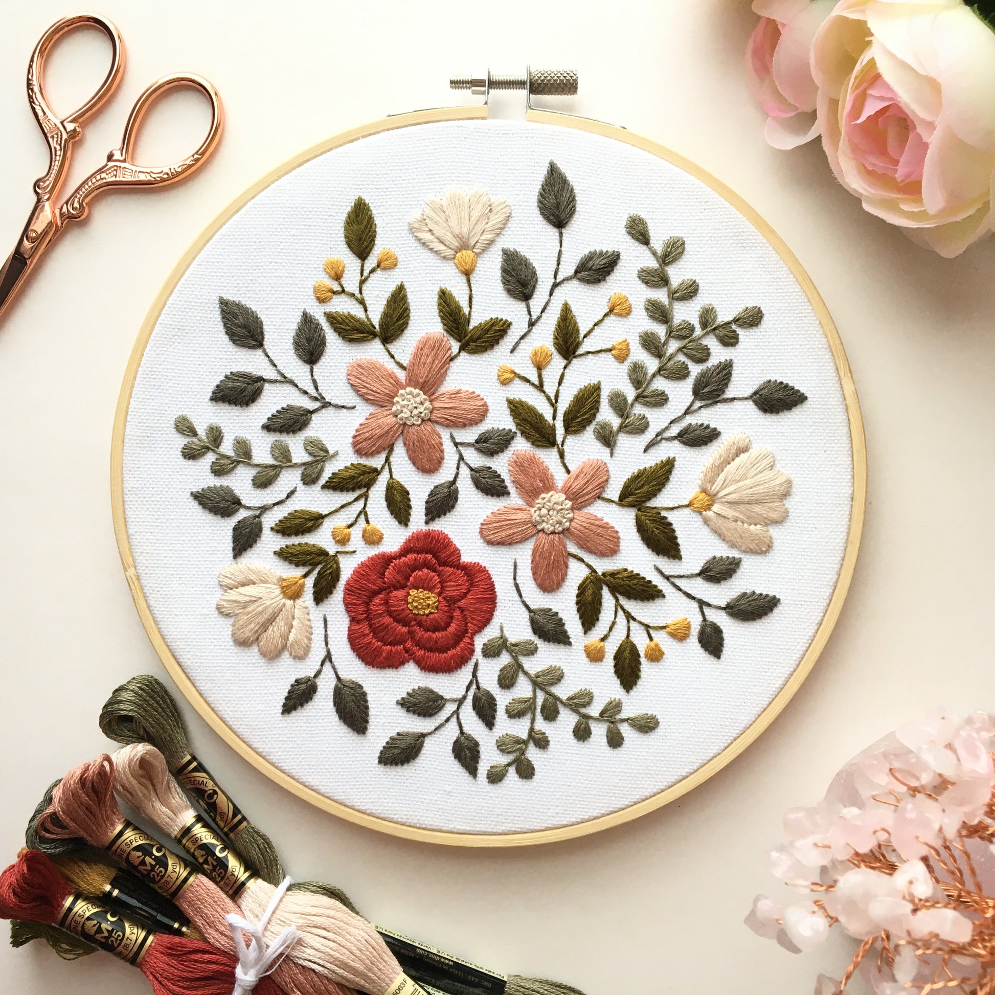 embroidery design featuring a burst of flowers and leaves in earthy hues by Eight22Crafts