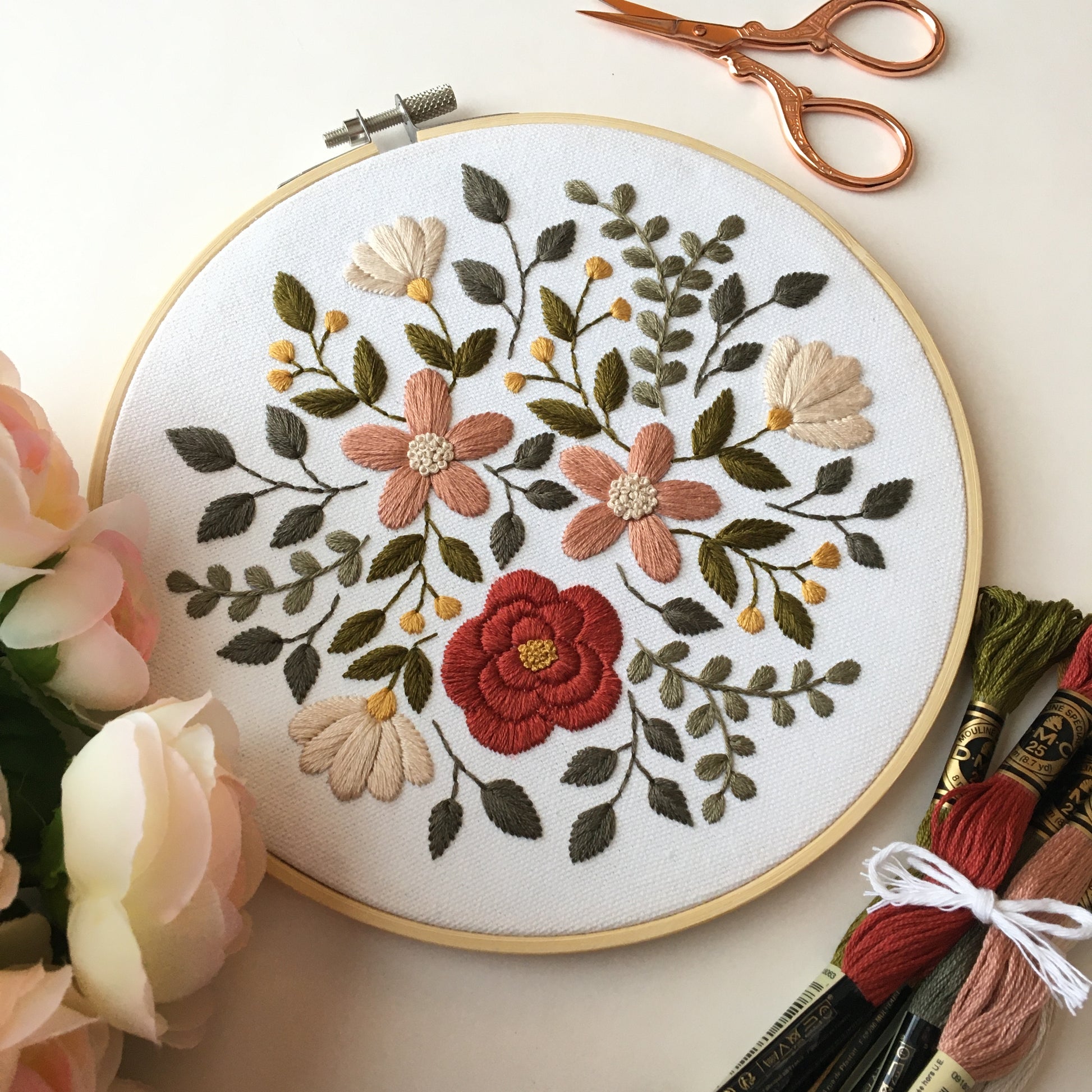 embroidery design featuring a burst of flowers and leaves in earthy hues by Eight22Crafts