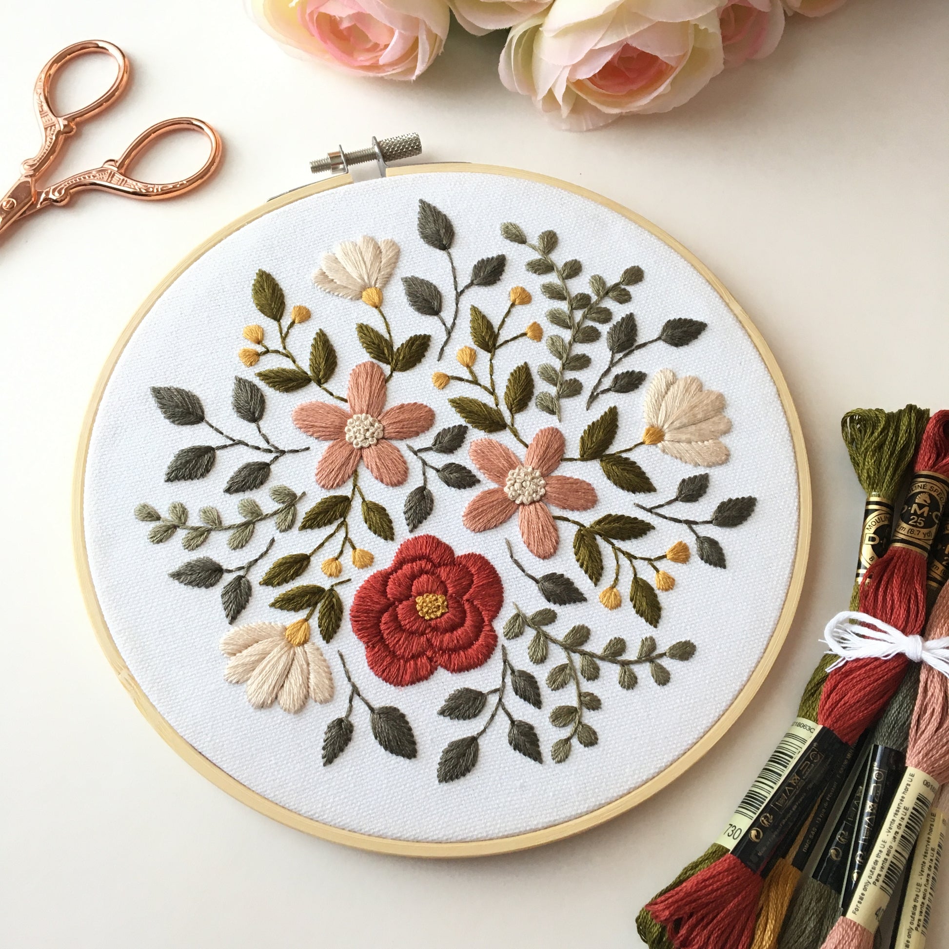 embroidery design featuring a burst of flowers and leaves in earthy hues by Eight22Crafts